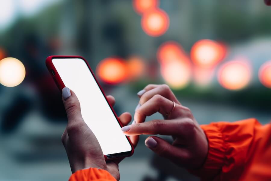 Resident using a mobile app on a smartphone with a city background.