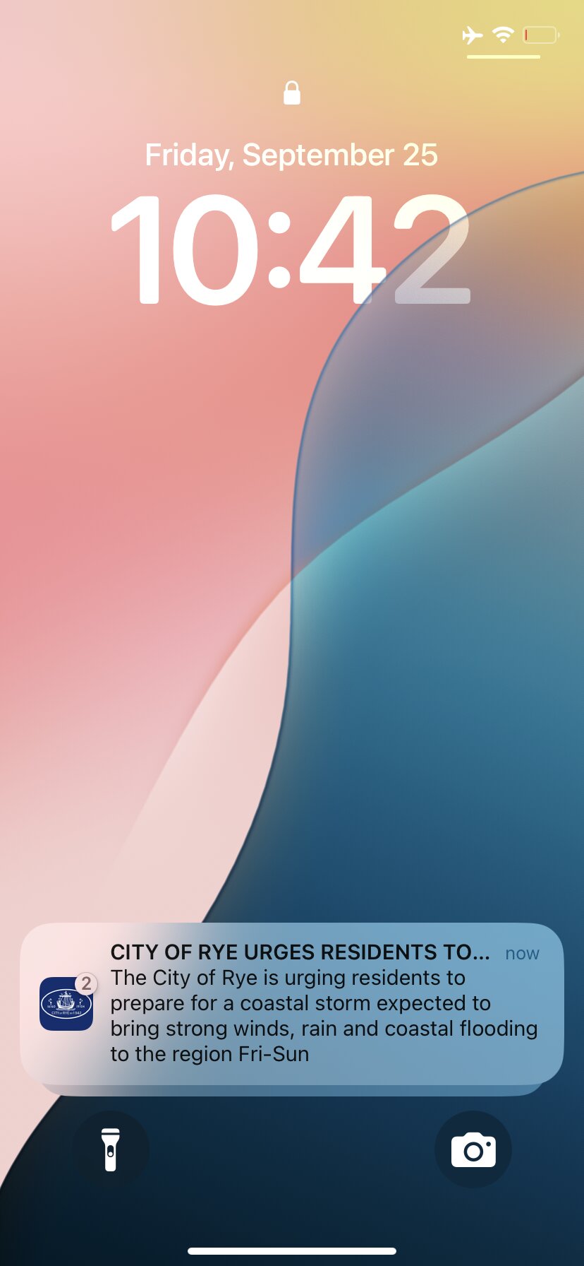 Phone lock screen showing a City of Rye app push notification urging residents to prepare for a coastal storm
